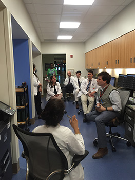 a group of doctors discussing a case in a work area