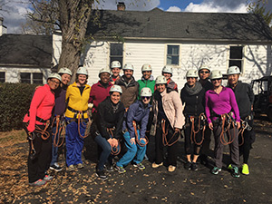 Inova residents wearing safety hats, harnesses and rock climbing gear